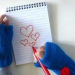 Oliver Twist,wrist high crochet fingerless mittens with removable pom-pom brooch in blue.