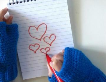 Oliver Twist,wrist high crochet fingerless mittens with removable pom-pom brooch in blue.